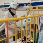 Nauczycielka w stroju Olafa czyta dla chłopca zagadkę umieszczoną na papierowej śnieżynce