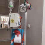 szpitalny stojak w mikołajki ozdobiony bombkami i portretem Mikołaja